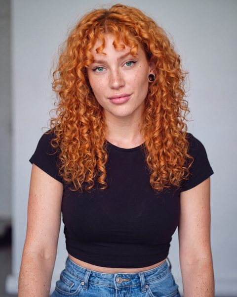Freya in a black cropped tee and high-waist jeans.